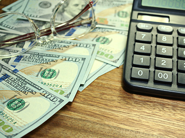Dollars, glasses and calculator